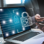lock icon floating with a laptop in the background