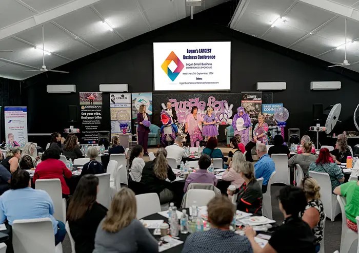 A group of people sitting at a conference